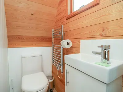 a small bathroom with a toilet and a sink at Pod No 28 in Keswick