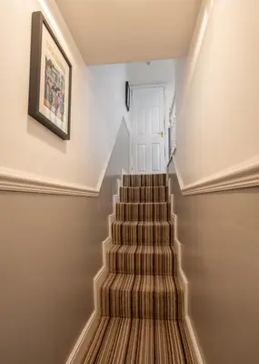 a staircase in a home with a picture on the wall at 25 Church Street in Keswick