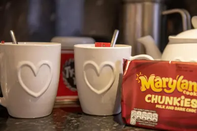 three coffee cups with hearts painted on them on a counter at 25 Church Street in Keswick