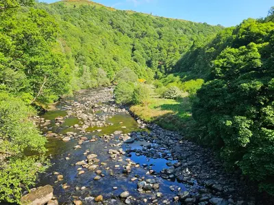 an aerial view of a river with rocks and trees at Briery House in Keswick
