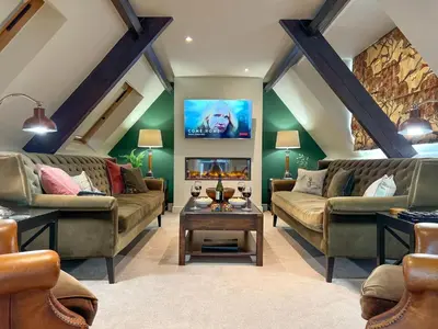 a living room with two couches and a fireplace at Geltsdale Wing, Wetheral 1st floor apartment with countryside views, close to pub & restaurant in Wetheral