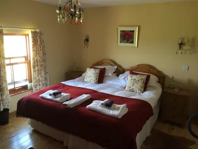 a bedroom with a bed with towels on it at Knockaloe Beg Farm in Patrick