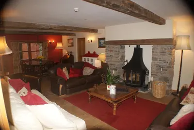 a living room with a couch and a fireplace at Knockaloe Beg Farm in Patrick