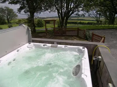 a bath tub filled with water in a yard at Criffel Glen in Dumfries