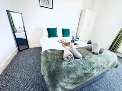 a hotel room with a bed with towels on it at The Georgian Townhouse - 4 Bedrooms - Sleeps 9 in Whitehaven