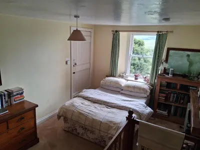 a bedroom with a bed and a window at Threecrofts Farm in Dumfries