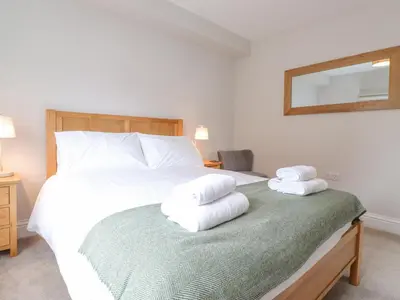 a bedroom with a bed with towels on it at 1 Millbank in Keswick