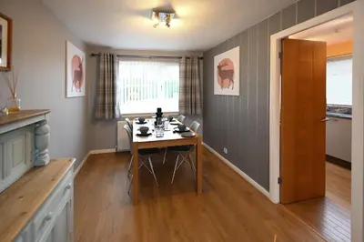 a kitchen with a table and chairs in a room at Links Golf Villa in Troon