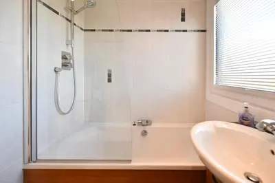 a bathroom with a shower and a sink at Links Golf Villa in Troon