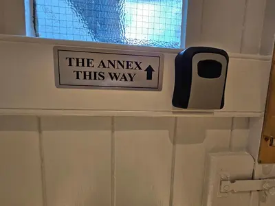 a sign that says the answer this way in a bathroom at Carlisle City Centre The Wash House in Carlisle