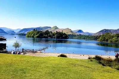 a view of a lake with mountains in the background at A charming luxury apartment! in Portinscale