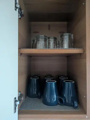 a cupboard with a bunch of glass jars on it at Loch's Heaven 67 in Kirkcowan