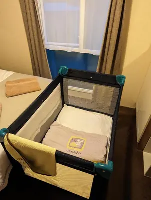 a small bed in a small room with auggage at Loch's Heaven 67 in Kirkcowan