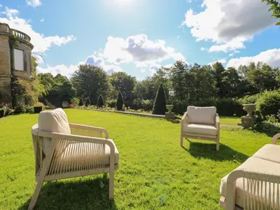 two chairs sitting in the grass in a yard at The Pavillion in Carlisle
