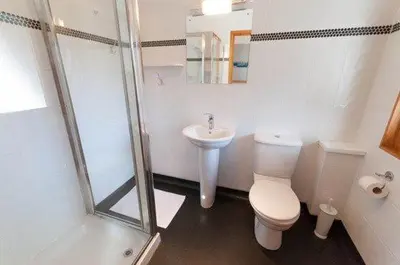 a bathroom with a toilet and a sink and a shower at Keswick Bridge 21, within walking distance of Keswick town centre, strictly no pets in Keswick
