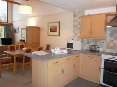 a kitchen with a counter and a table with a microwave at Keswick Bridge 17, within walking distance of Keswick town centre, strictly no pets in Keswick
