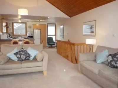 a living room with two couches and a kitchen at Keswick Bridge 17, within walking distance of Keswick town centre, strictly no pets in Keswick