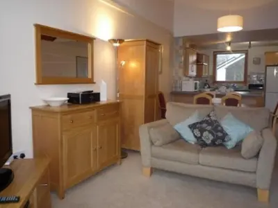 a living room with a couch and a kitchen at Keswick Bridge 19, within walking distance of Keswick town centre, strictly no pets in Keswick