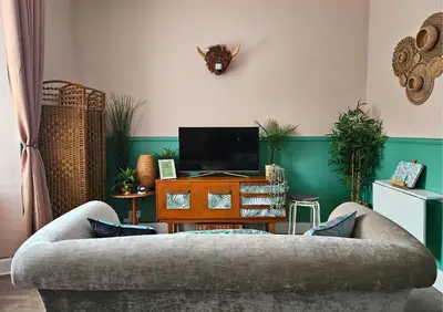 a living room with a couch and a tv at The Ferns - Modern Apartment With Parking & Shared Garden in Darvel