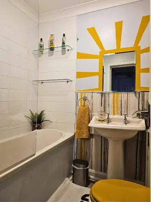 a bathroom with a sink and a tub and a toilet at The Ferns - Modern Apartment With Parking & Shared Garden in Darvel