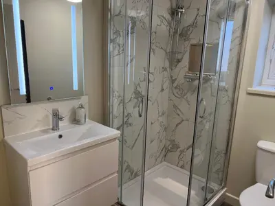 a bathroom with a shower and a sink at Loudoun Mains Luxury Lodges in Newmilns