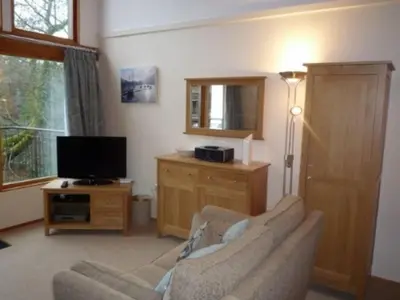 a living room with a couch and a television at Keswick Bridge 6, within walking distance of Keswick town centre, strictly no pets in Keswick