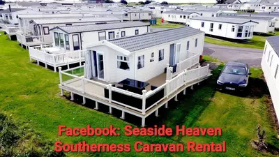 a house with a car parked in front of it at Seaside Heaven - Southerness Caravan Rental in Mainsriddle