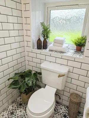 a white bathroom with a toilet and a window at The Cottage @ 59 in Colmonell