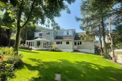 a house with a large yard with green grass at Number Fifty-Six Ramsey Villa in Ramsey