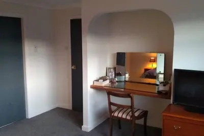 a desk in a hotel room with a mirror at Number Fifty-Six Ramsey Villa in Ramsey