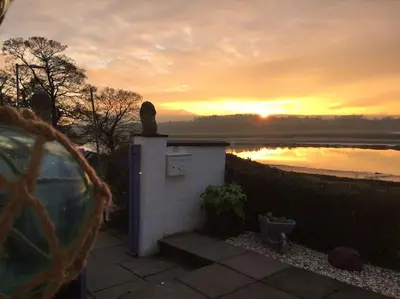 a small building with a statue on top of it at Shorepark - waterfront cottage with stunning views in Dumfries