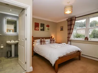 a bedroom with a bed and a sink and a window at Castle Crag in Keswick