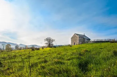 an old barn on a hill in a field at The Hidden Place in Penrith