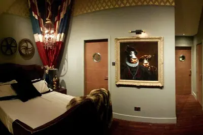 a bedroom with a bed and a painting on the wall at Bonshaw Grange-Riverside Country Retreat, & HotTub in Lockerbie