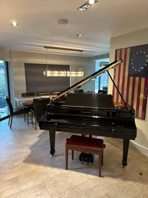 a living room with a piano and a table at Bonshaw Grange-Riverside Country Retreat, & HotTub in Lockerbie