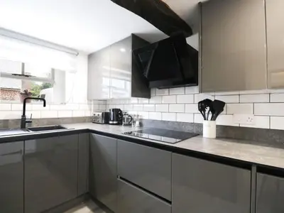 a kitchen with stainless steel cabinets and a sink at The Hollies in Carlisle