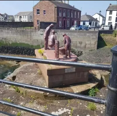 a statue of three men working on a wall at Church House Barn Lake District & Solway Coast with Solway Firth views in Silloth