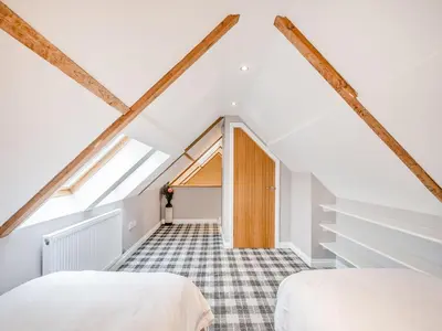 two beds in a attic bedroom with exposed beams at The Byre - Uk45343 in Ayr