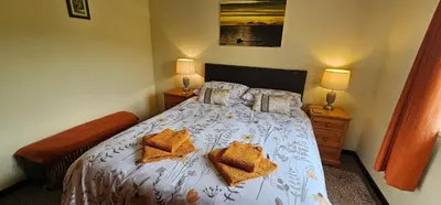 a bedroom with a bed with two pillows on it at Ash Cottage in Stranraer