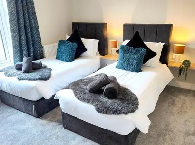 two beds in a room with at Carvetii - ANNE House Room 1 - Dbl bed Ground floor en-suite in Carlisle