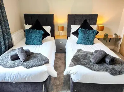 two beds with pillows on them in a bedroom at Carvetii - ANNE House Room 1 - Dbl bed Ground floor en-suite in Carlisle