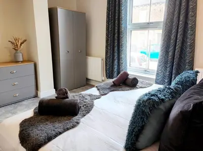 a bedroom with a bed with pillows and a window at Carvetii - ANNE House Room 1 - Dbl bed Ground floor en-suite in Carlisle