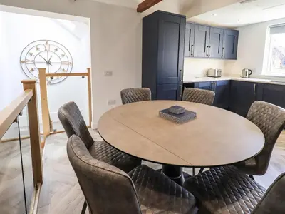 a dining room with a table and chairs at Mallard Cottage Lake District, Leisure Spa Pool & Gym in Penruddock