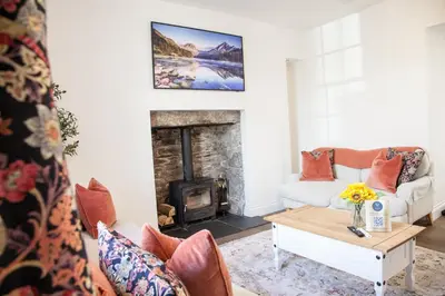a living room with a couch and a fireplace at Stunning Scottish Hot Tub Getaway in Gatehouse of Fleet