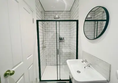 a bathroom with a shower and a sink and a mirror at Stunning Scottish Hot Tub Getaway in Gatehouse of Fleet
