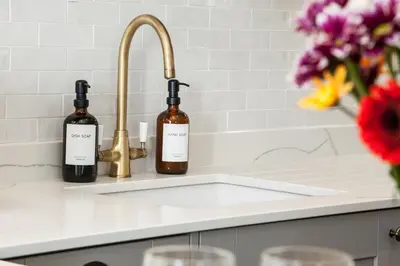a kitchen counter with two bottles of wine on a sink at Stunning Scottish Hot Tub Getaway in Gatehouse of Fleet
