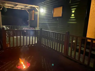 a fire pit on the porch of a house at Inglenook Caravan in Lamplugh