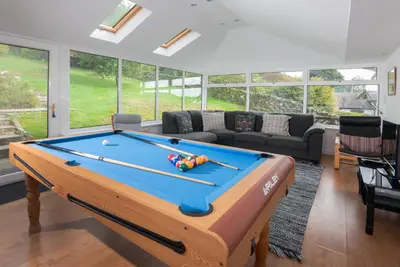 a living room with a pool table in front at Spedding Fold Chapel Stile in Chapel Stile