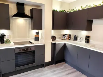 a kitchen with white counter tops and brown cabinets at Carvetii - ANNE House Room 2 - Dbl bed First floor en-suite in Carlisle