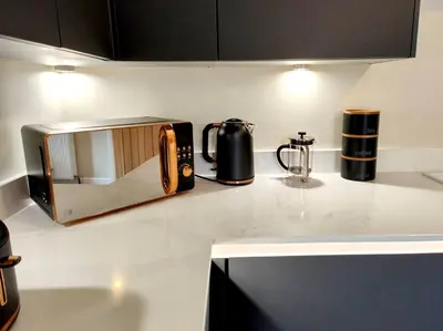 a kitchen counter with a toaster and a microwave on it at Carvetii - ANNE House Room 2 - Dbl bed First floor en-suite in Carlisle